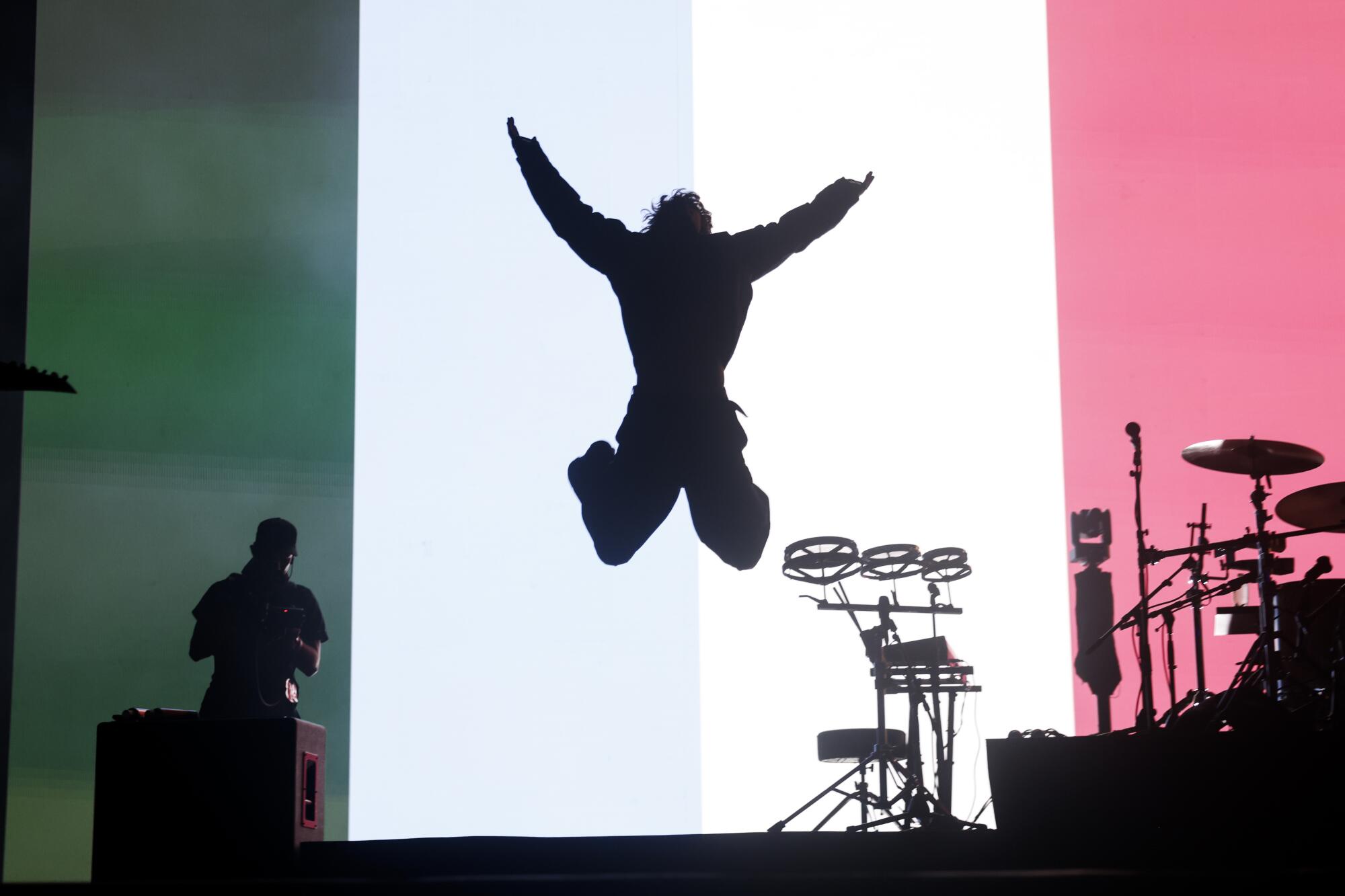 silhouette of Turnstile's singer leaping in the air