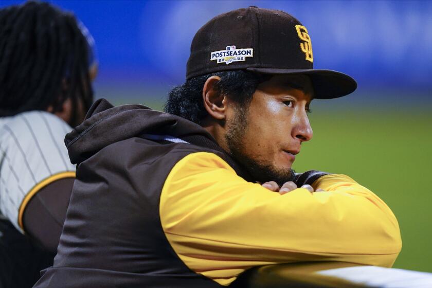 San Diego Padres pitcher Yu Darvish watches play from the dugout during Game 2.