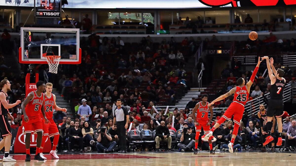 Goran Dragic of the Miami Heat puts up a three point shot over Denzel Valentine of the Chicago Bulls on his way to a team-high 24 points at the United Center.