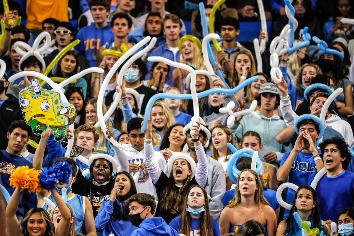 UCLA fans wave balloons in an effort to distract a free-throw shooter.