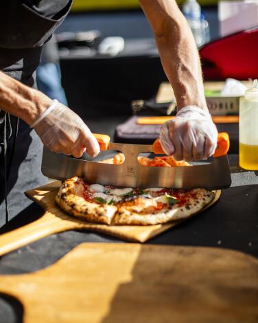 A freshly cooked pizza being prepared at a pop up event for Miller Butler at Brouwerji West in San Pedro