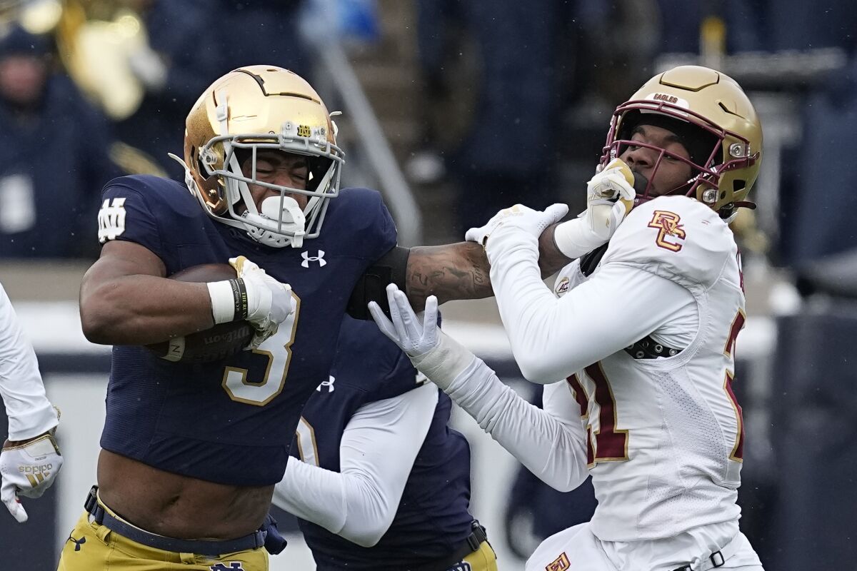 Notre Dame running back Logan Diggs stiff-arms Boston College defensive back Josh DeBerry during last week's game.