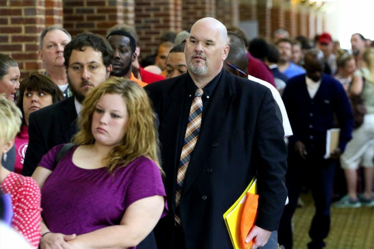 Hundreds of job seekers wait in line at a job fair in Ringgold, Ga.