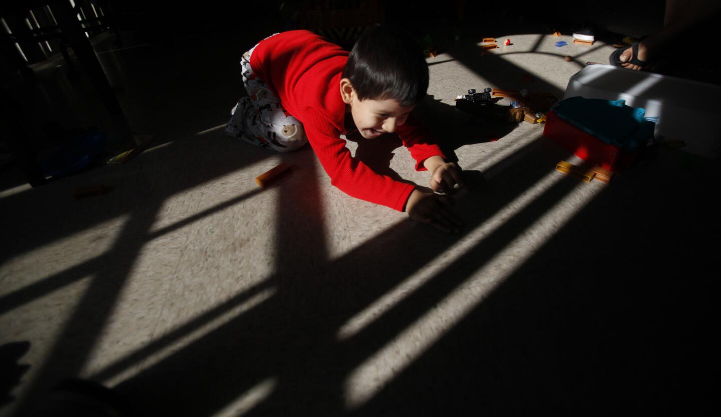 Nathan Salazar, 4, plays in the in living room of his family's University Park apartment. Allenco Energy Co. temporarily suspended operations across the street from the family's apartment. The L.A. city attorney said in a lawsuit that lax practices by Allenco exposed University Park residents to noxious fumes and odors which have resulted in adverse health effects.