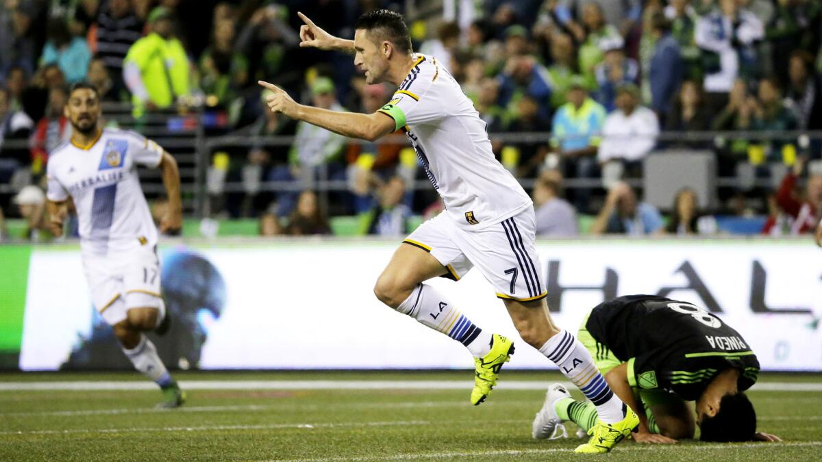 Galaxy forward Robbie Keane and Sounders midfielder Gonzalo Pineda react after Keane scored in the first half Sunday night in Seattle.