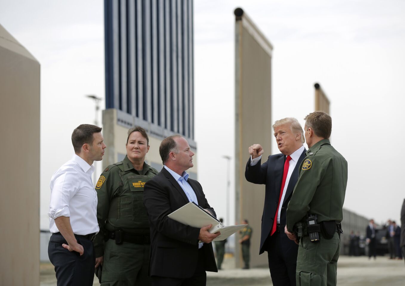 President Trump and officials discuss proposed border wall prototypes near San Diego on March 13.