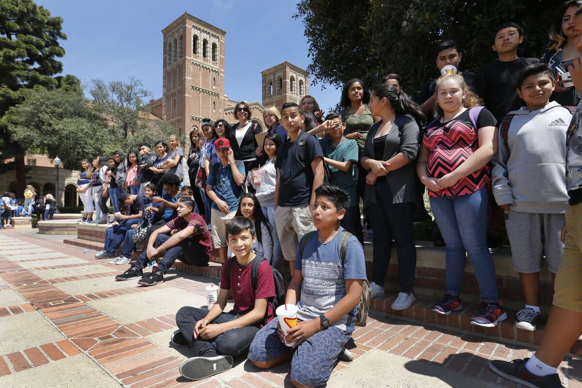 Jesus Perez, 13, center in blue shorts, an 8th grader from Mountain View Middle School in Moreno Valley, joins his classmates visiting UCLA.