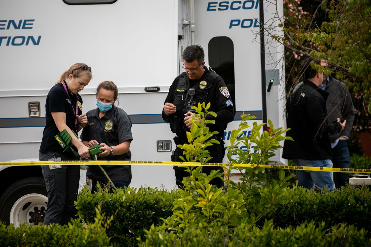 Escondido Police Department investigators search for evidence