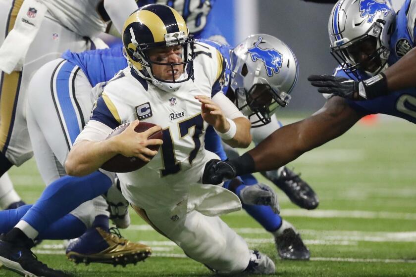 Rams quarterback Case Keenum is tackled by Lions outside linebacker Kyle Van Noy and defensive tackle Tyrunn Walker (93) during an Oct. 16 game in Detroit.