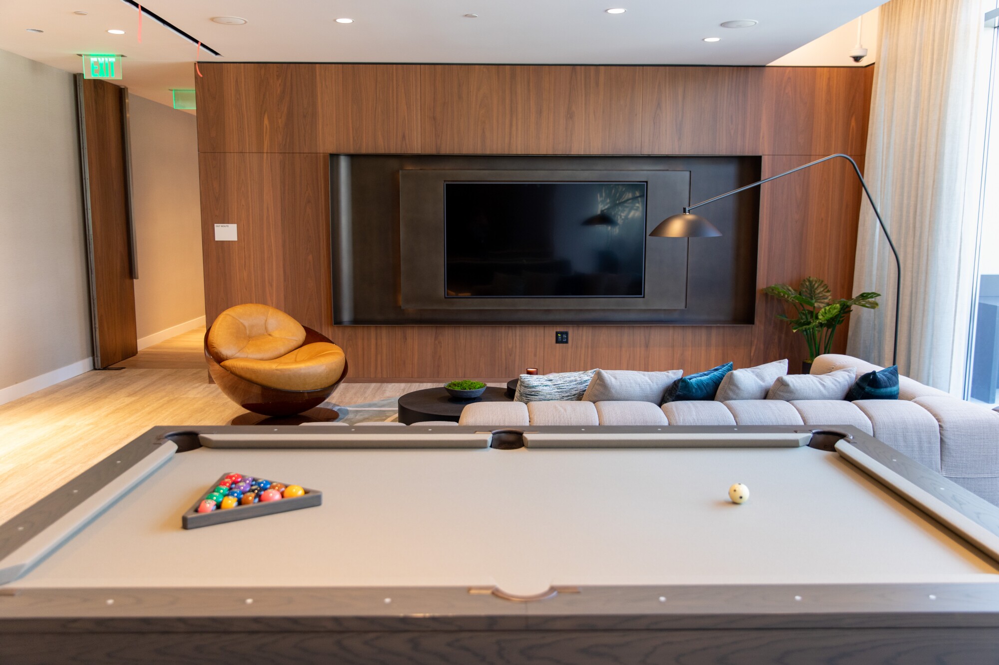 The Grand Lounge bar and theater features a custom billiards table and 85