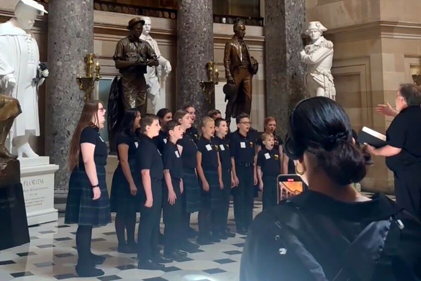 In this image taken from a video, the Rushingbrook Children’s Choir sings the “Star-Spangled Banner” in the U.S. Capitol’s Statuary Hall on Friday, May 26, 2023, in Washington. Social media users are claiming the Greenville, South Carolina, group was cut off as it was singing the national anthem because it could be deemed “offensive.” But Capitol Police say that such public displays aren’t allowed in the hallowed seat of Congress without proper approval and that the show in National Statuary Hall was stopped because there was a miscommunication about whether the choir had permission to be there. (AP Photo/Farnoush Amiri)