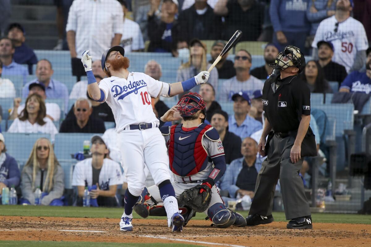 Dodgers third baseman Justin Turner leans back with his arms spread after popping out.