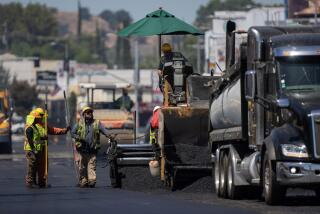 Woodland Hills, CA - July 27: Heat radiates up off fresh asphalt as LA City street services workers lay down new pavement on Ventura Blvd. on Thursday, July 27, 2023 in Woodland Hills, CA. (Brian van der Brug / Los Angeles Times)