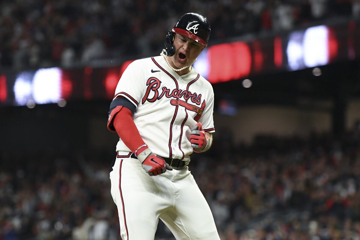 Atlanta Braves' Joc Pederson celebrates while rounding the bases off a two-run home run.