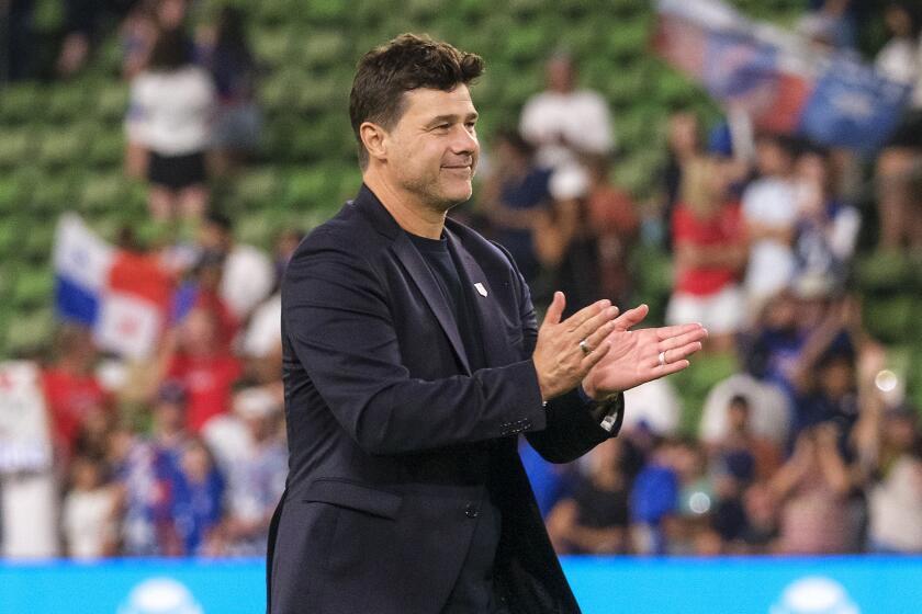 United States head coach Mauricio Pochettino celebrates with fans after defeating Panama.