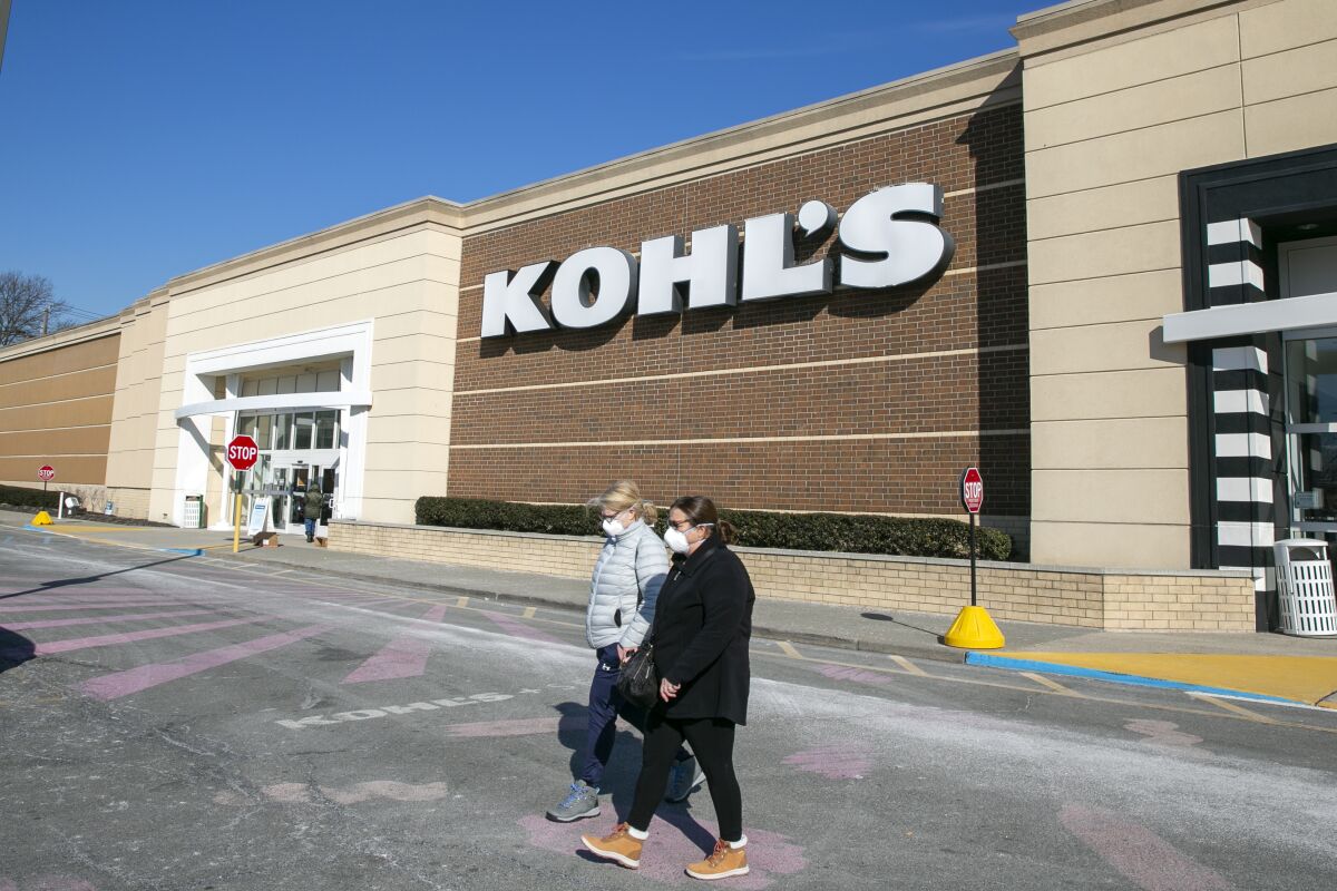 FILE - People walk by a Kohl's department store in Clifton, New Jersey, on Jan. 27, 2022. Shares of Kohl's are up more than 12% before the market open on Tuesday, June 7, after the retailer announced that it is in exclusive takeover talks with the owner of Vitamin Shoppe.(AP Photo/Ted Shaffrey, File)