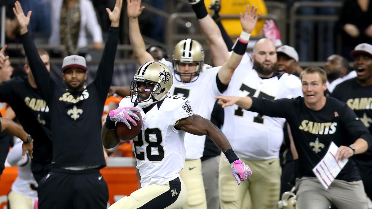 Saints running back C.J. Spiller (28) heads to the end zone on an 80-yard pass play in a 26-20 overtime win against the Cowboys on Sunday.