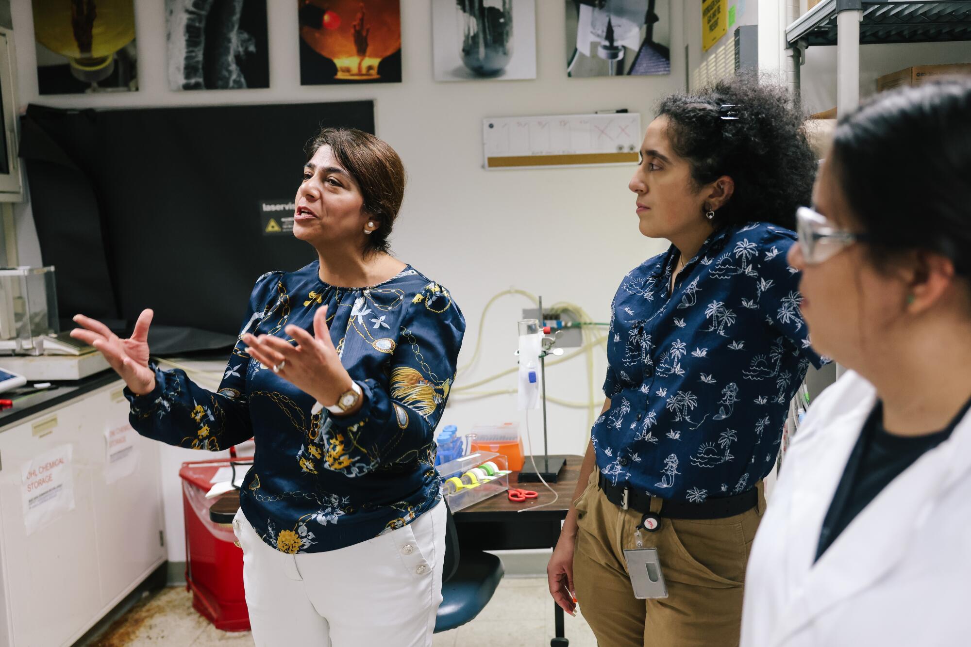 A Cal State L.A. associate professor speaks with students in a lab setting. 