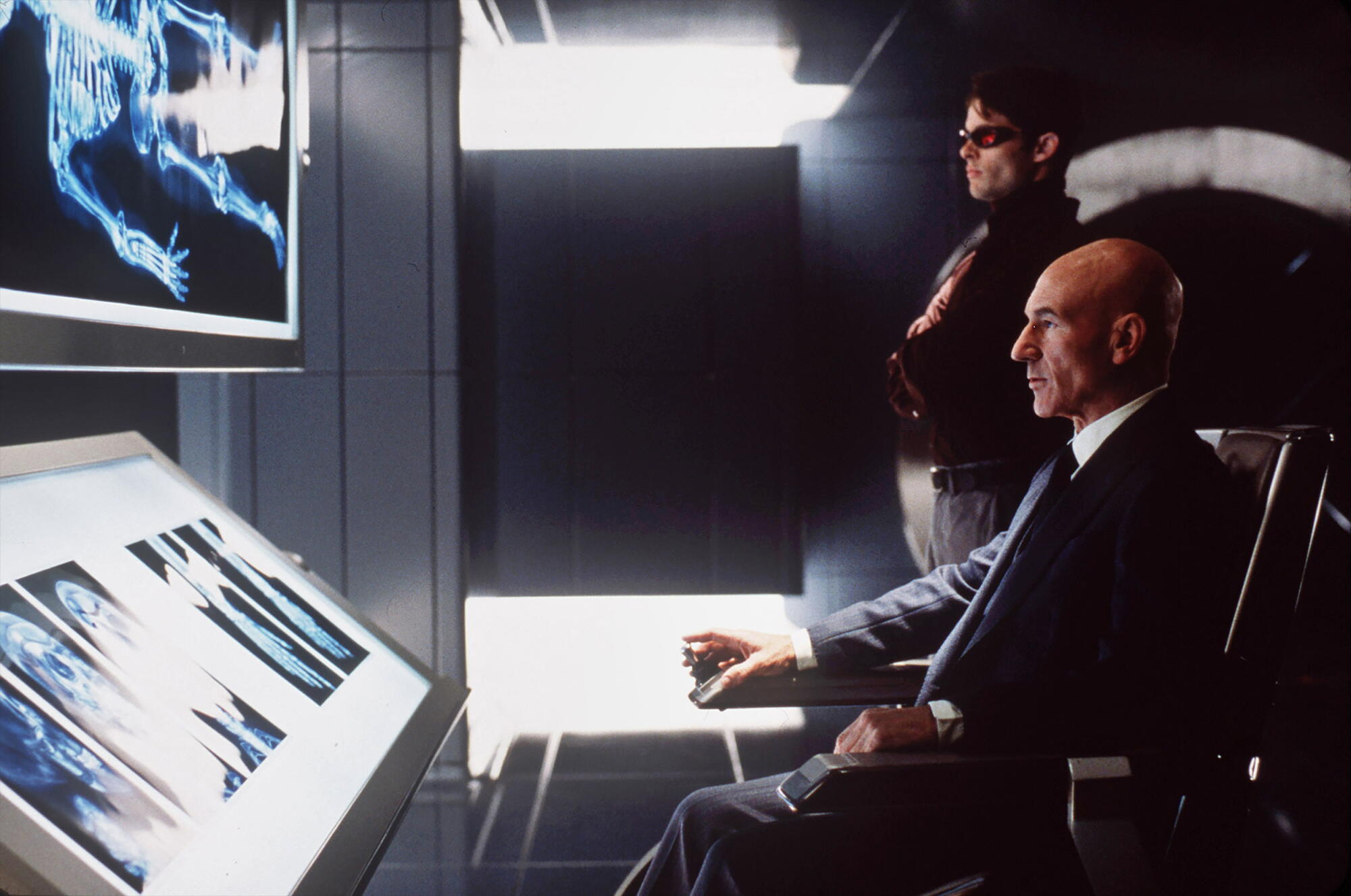 James Marsden and Patrick Stewart, sitting in a wheelchair, look at X-rays in 