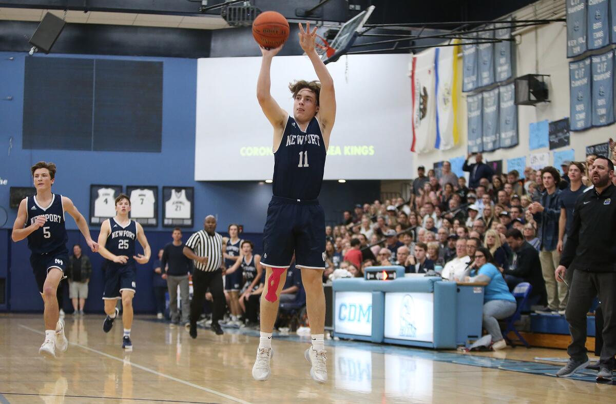 Newport Harbor's Levi Darrow makes a three-pointer in the Battle of the Bay game at Corona del Mar on Friday.