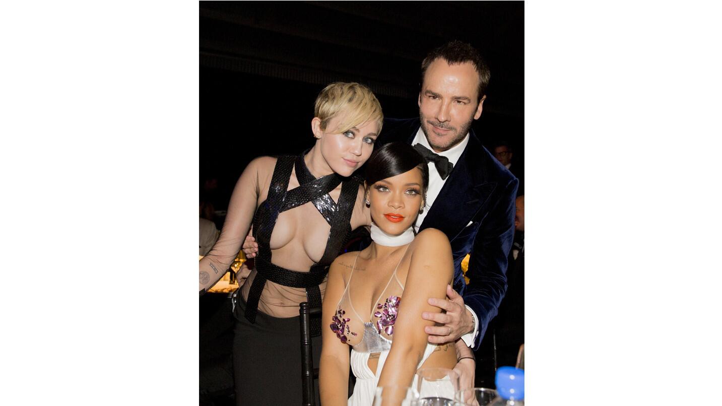 Miley Cyrus, left, and Rihanna with -- and dressed in -- Tom Ford create an unforgettable vision at the amfAR Inspiration Gala honoring him.