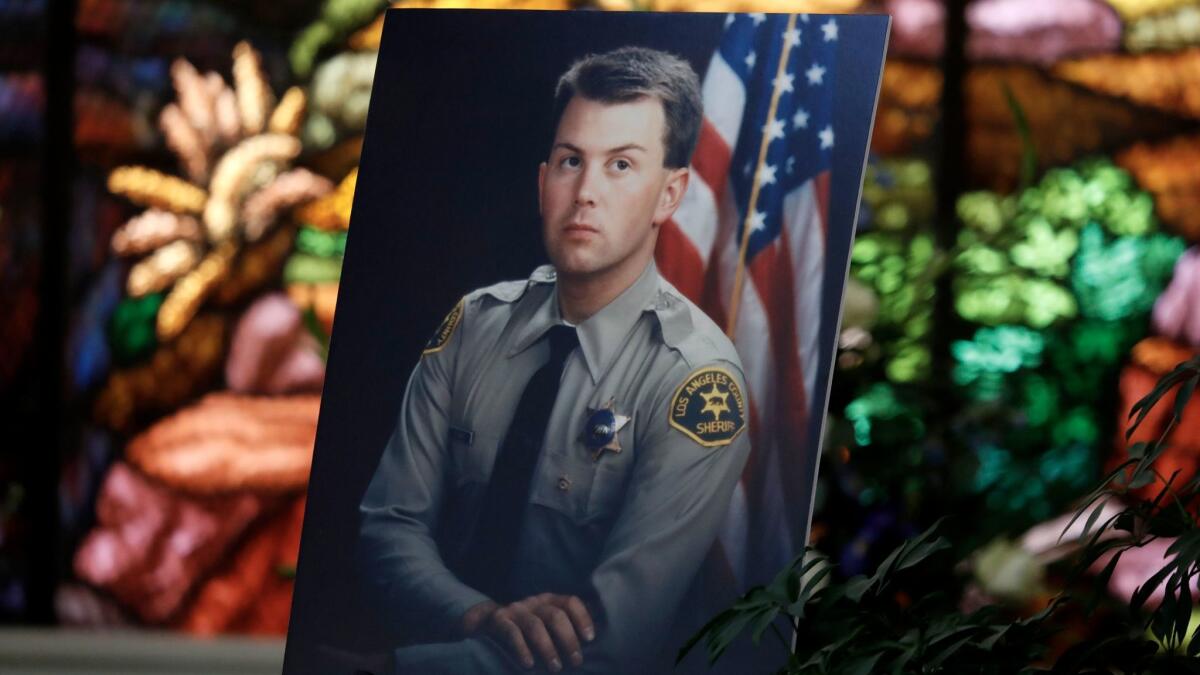 Steven Belanger, who was shot in the head during a motor vehicle stop in 1994, is pictured during his tenure as an L.A. County sheriff's deputy in a photo at his funeral this week.