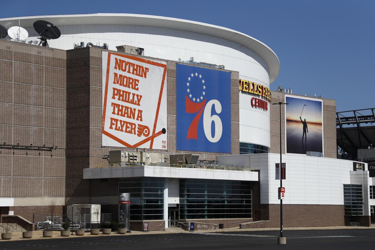 FILE - Wells Fargo Center, home of the Philadelphia Flyers NHL hockey team and the Philadelphia 76ers NBA basketball team, is shown March 14, 2020. The Philadelphia 76ers, who currently play at Wells Fargo Center, are taking the first steps toward building a privately-funded sports and entertainment arena. The team's managing partners on Thursday, July 21, 2022, announced the creation of a new development company to create its future home in the city's Fashion District. (AP Photo/Matt Slocum, File)