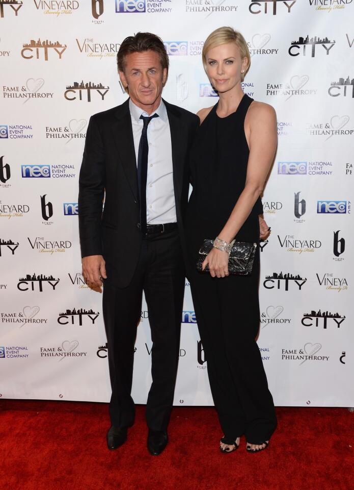 Sean Penn and Charlize Theron attend the Fame and Philanthropy party at the Vineyard in Beverly Hills after the 2014 Academy Awards.