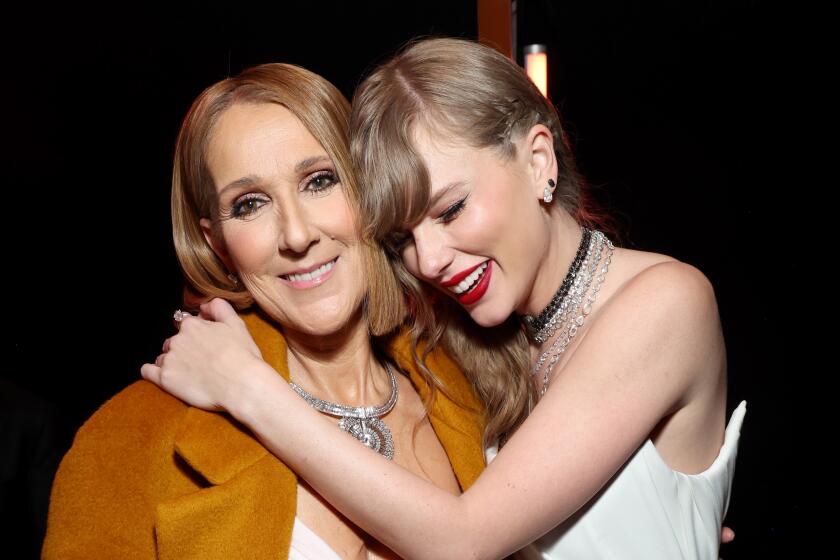 Taylor Swift, right, hugs and smiles with singer Celine Dion