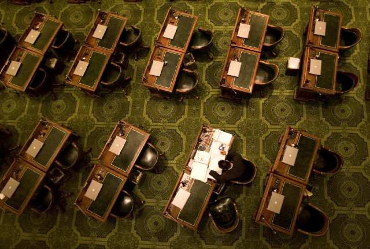 SACRAMENTO, CA - MAY 12, 2008: Assemblyman Todd Spitzer (R-Orange) studies a bill long after his colleagues have adjourned for day, May 12, 2008 on the floor of the state Assembly in Sacramento, California. He said it was easier to study the bill at his desk in the Assembly chambers than pick up all his materials and return to his office. The bill would expand eligibility for food stamps for those convicted of drug offenses. (Robert Durell/Los Angeles Times)
