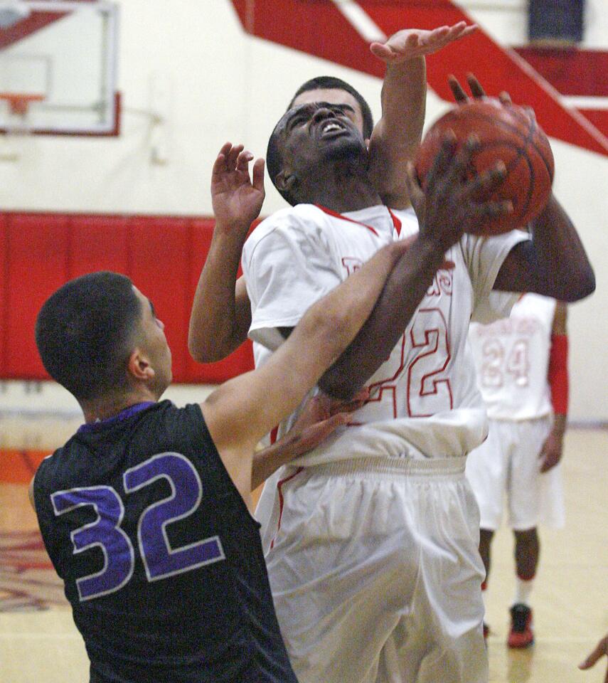 Pasadena's Hurschel Langham, at the buzzer to end the third quarter, is fouled by Hoover's Arvin Atakhanian with his teammate Teo Davidian reaching from behind to prevent a shot at Pasadena High School in a Pacific League boys basketball game at on Friday, January 4, 2013.