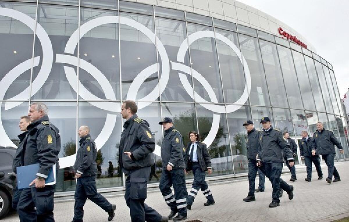 Police in Copenhagen inspect the site of this week's International Olympic Committee meeting. Chicago, Madrid, Tokyo and Rio de Janeiro are vying to host the 2016 Games.