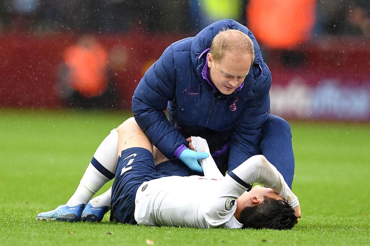 Tottenham Hotspur's South Korean striker Son Heung-Min holds his arm as he lies injured on the pitch during the English Premier League football match between Aston Villa and Tottenham Hotspur at Villa Park in Birmingham, central England on February 16, 2020. - Korean star Son Heung-min has fractured his right arm his club Tottenham Hotspur said on Tuesday, delivering a blow to their hopes of silverware this season and qualifying for the Champions League next season. (Photo by Justin TALLIS / AFP) / RESTRICTED TO EDITORIAL USE. No use with unauthorized audio, video, data, fixture lists, club/league logos or 'live' services. Online in-match use limited to 120 images. An additional 40 images may be used in extra time. No video emulation. Social media in-match use limited to 120 images. An additional 40 images may be used in extra time. No use in betting publications, games or single club/league/player publications. / (Photo by JUSTIN TALLIS/AFP via Getty Images) ** OUTS - ELSENT, FPG, CM - OUTS * NM, PH, VA if sourced by CT, LA or MoD **