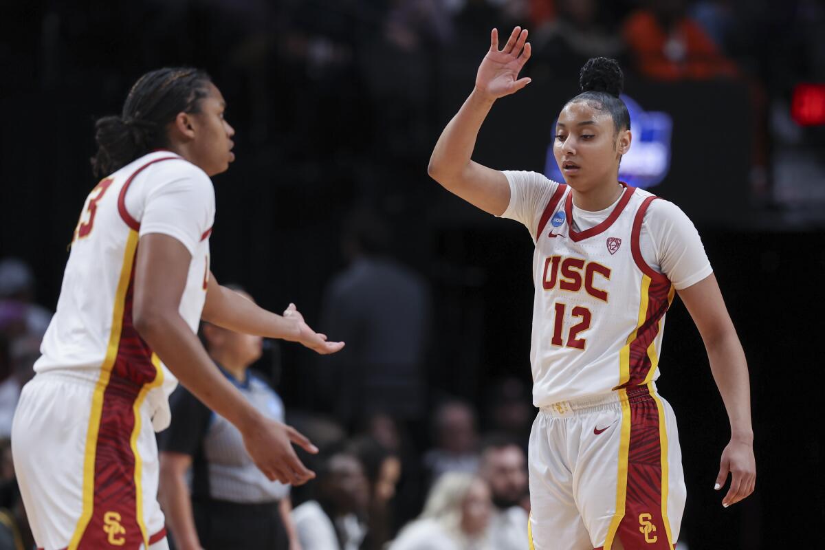 USC center Rayah Marshall, left, and guard JuJu Watkins greet one another on the court during the first half Saturday.