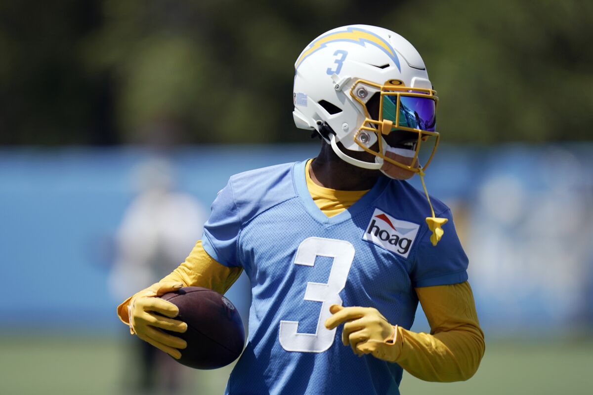 Chargers safety Derwin James Jr. cradles the football during practice.