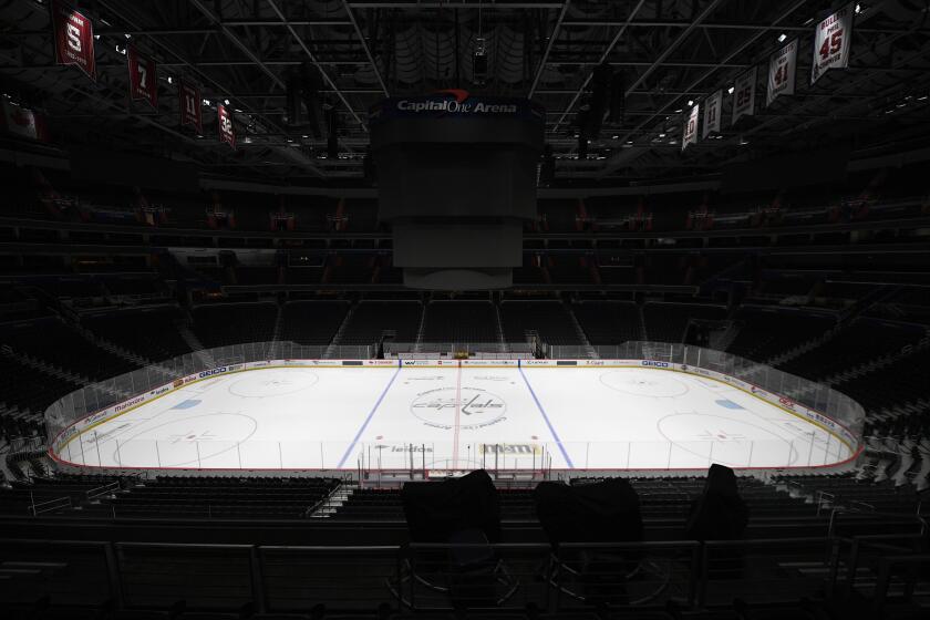 FILE - This is a March 12, 2020, file photo showing Capital One Arena, home of the Washington Capitals NHL hockey club in Washington. Get used to the concept of pods and pucks if the NHL is going to have any chance of completing its season, with the most likely scenarios calling for games in empty, air-conditioned arenas during the dog days of summer. (AP Photo/Nick Wass, File)
