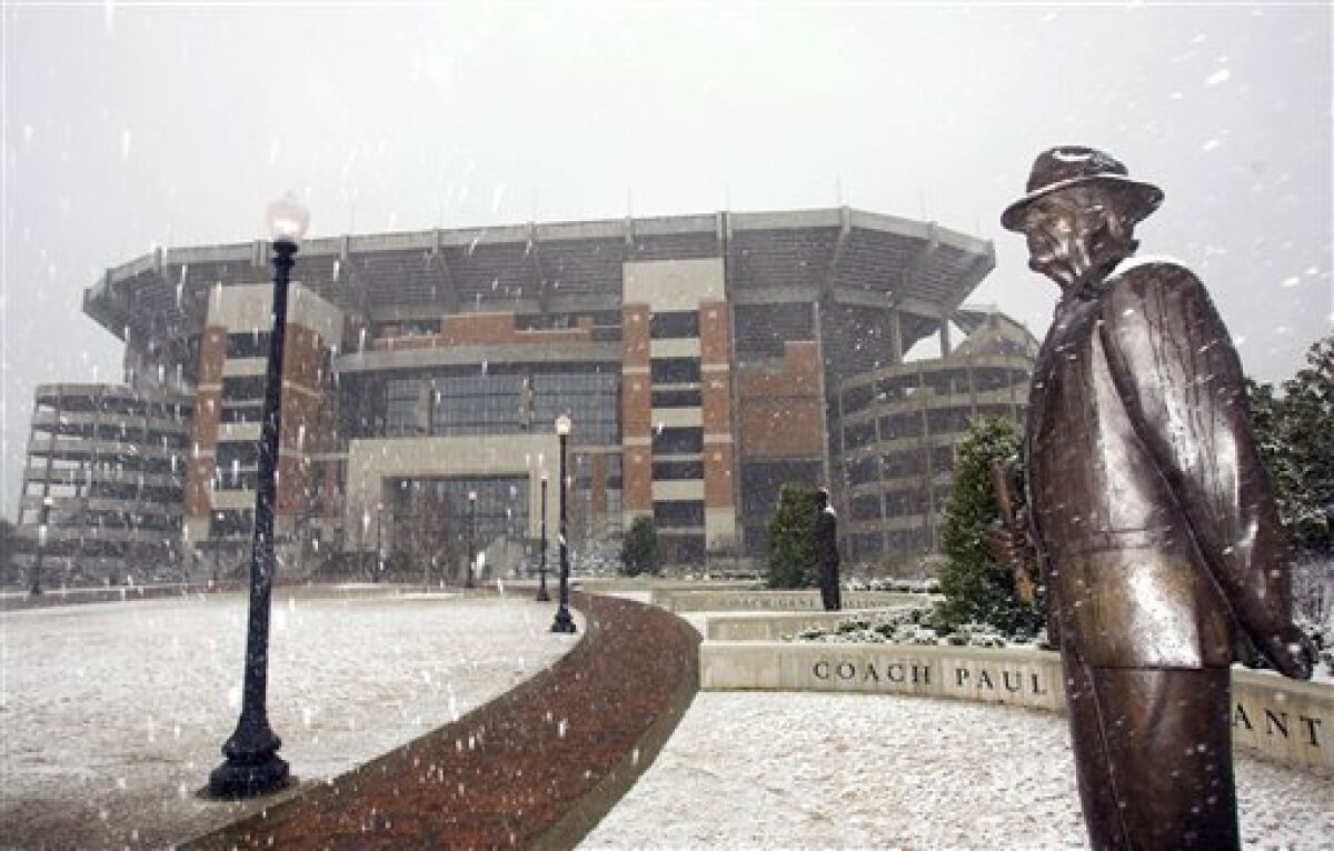 Snow falls on a statue of former University of Alabama football coach Paul "Bear" Bryant in front of Bryant-Denny Stadium on the University of Alabama campus in Tuscaloosa, Ala., Sunday, March 1, 2009.