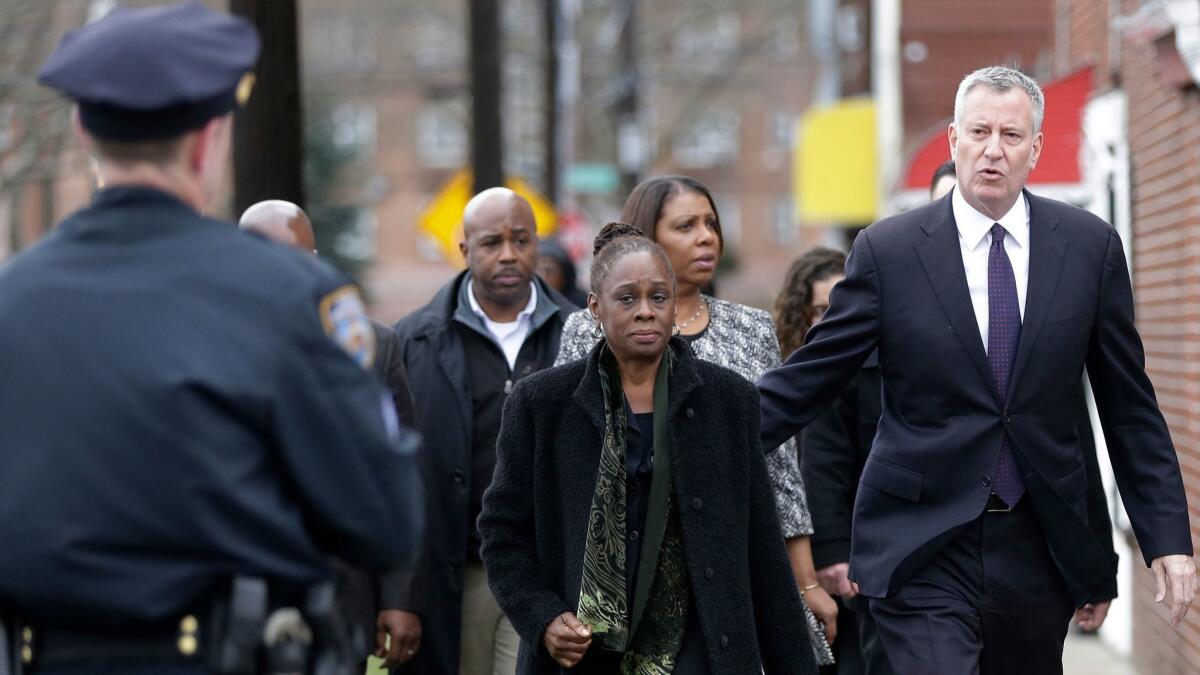 New York City Mayor Bill de Blasio and his wife, Chirlane McCray, arrive at funeral services for Timothy Caughman on April 1 in New York.