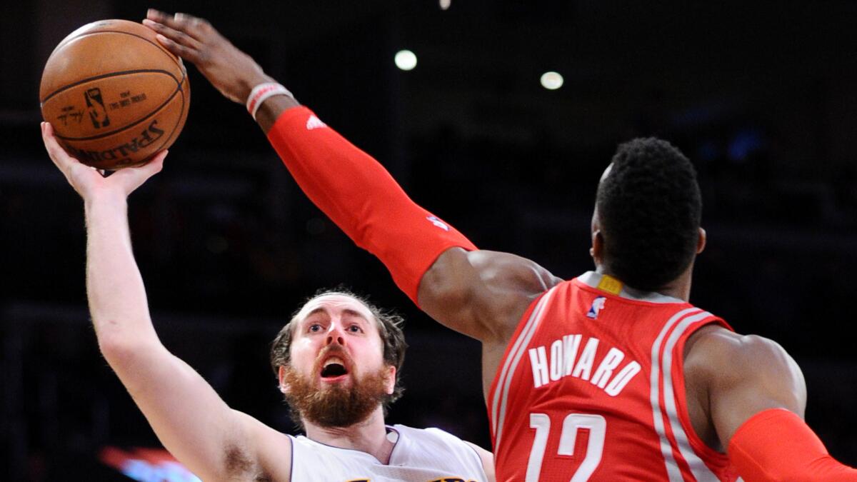 Rockets center Dwight Howard blocks a shot by Lakers forward Ryan Kelly during the first half.