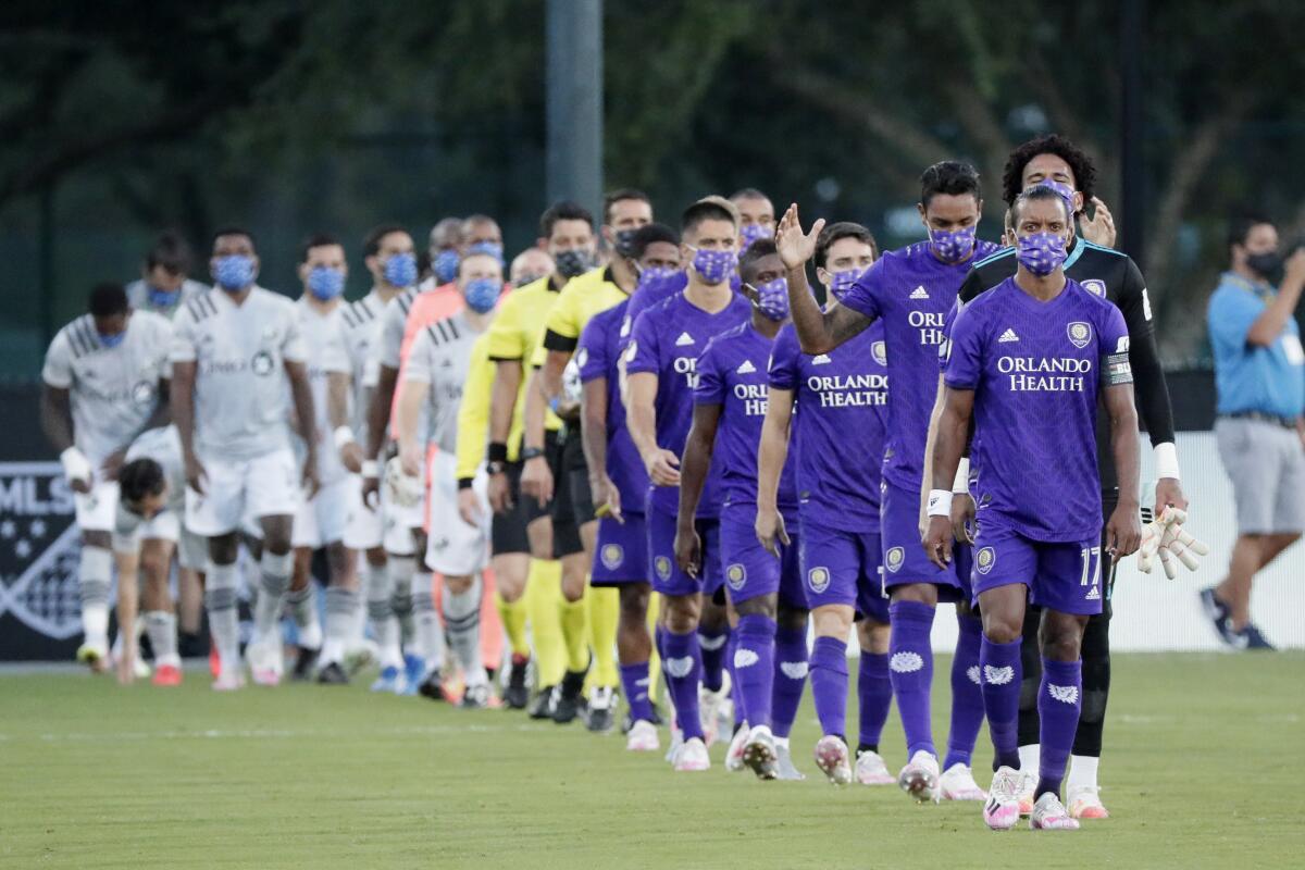 Orlando City and Montreal take to the field wearing masks before their July 25 game. 