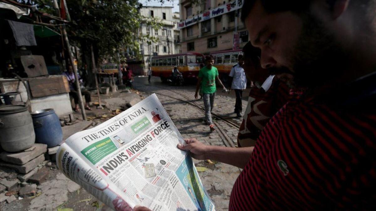 An Indian man reads a Feb. 27 newspaper detailing airstrikes the day before in Pakistan. During India and Pakistan's recent clashes, a deluge of fake news on social media, sometimes picked up by traditional media, fueled calls for escalation.