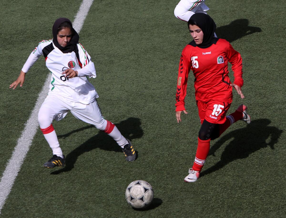 Soccer players vying for the ball