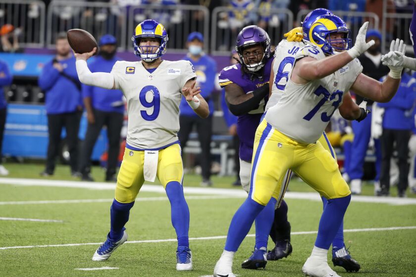 Los Angeles Rams quarterback Matthew Stafford (9) throws a pass during the second half of an NFL football game against the Minnesota Vikings, Sunday, Dec. 26, 2021, in Minneapolis. (AP Photo/Bruce Kluckhohn)