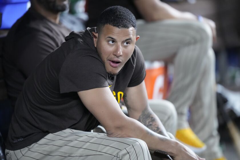 San Diego Padres' Manny Machado looks out of the dugout during the eighth inning of a baseball game against the Miami Marlins, Thursday, June 1, 2023, in Miami. (AP Photo/Wilfredo Lee)