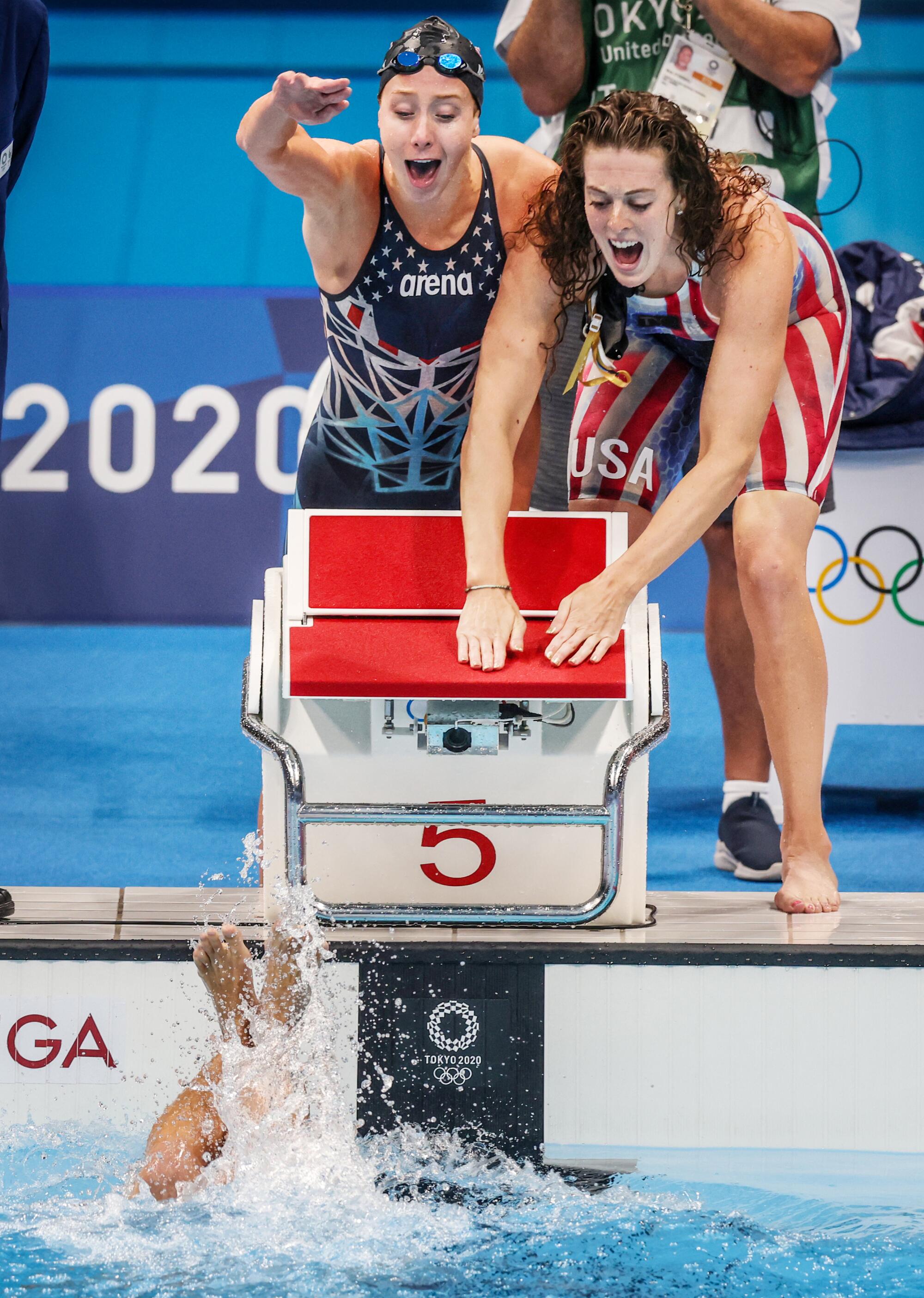 U.S. teammates Paige Madden, left, and Allison Schmitt cheer on Katie Ledecky in the final of the 800-meter relay.