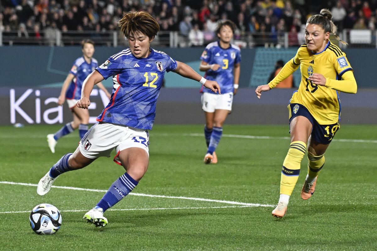 Japan's Hana Takahashi kicks the ball clear of Sweden's Johanna Kaneryd during a World Cup quarterfinal match