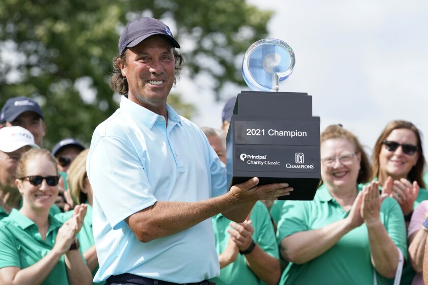 Stephen Ames holds the trophy after winning the PGA Tour Champions Principal Charity Classic golf tournament, Sunday, June 6, 2021, in Des Moines, Iowa. (AP Photo/Charlie Neibergall)