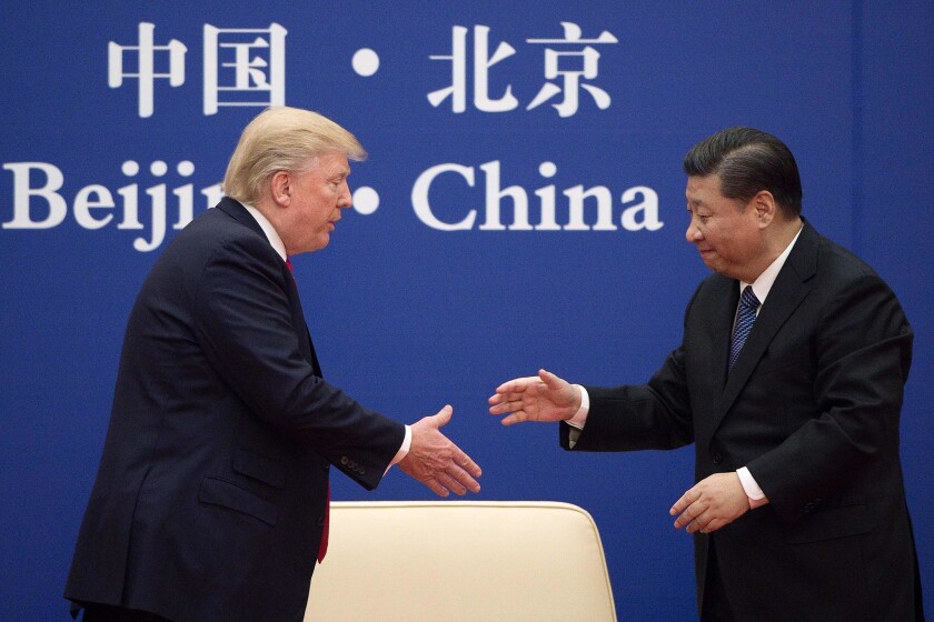 President Trump shakes hands Chinese President Xi Jinping during a business leaders event in Beijing on Nov. 9, 2017.