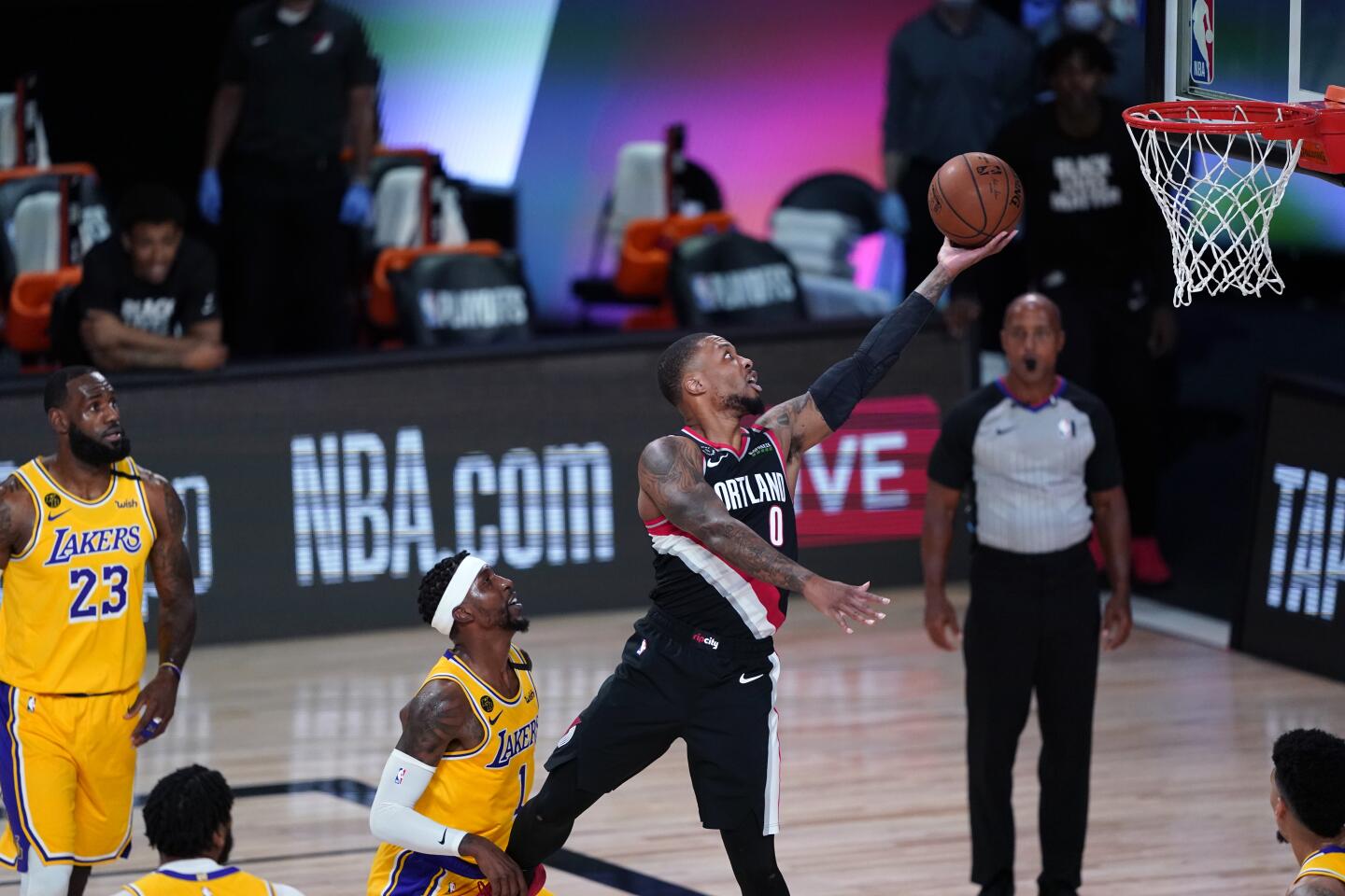 Portland Trail Blazers guard Damian Lillard goes to the basket over Los Angeles Lakers guard Kentavious Caldwell-Pope during the first half.