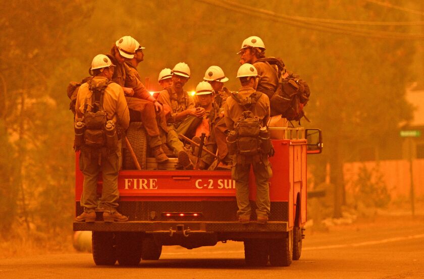 Firefighters arrive at the scene as flames from the Caldor fire push into South Lake Tahoe, California on August 30, 2021